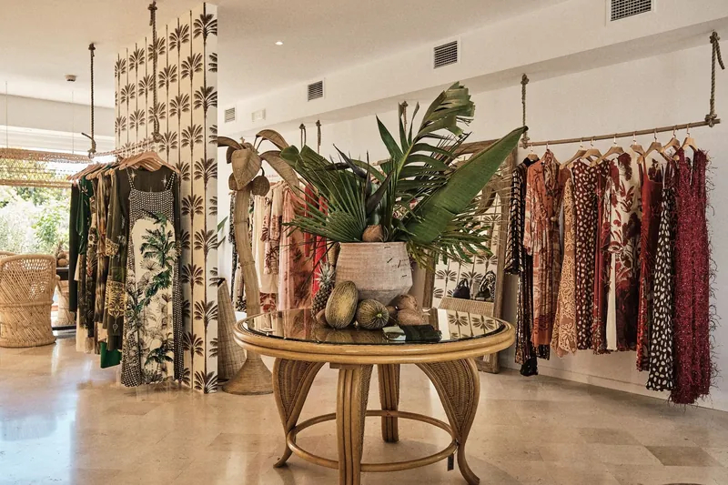 Marbella Club summer boutique with printed dresses, plants and rattan furniture