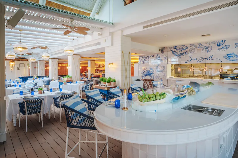 Puente Romano Marbella Sea Grill dining room with white seafood bar and blue-and-white tiles
